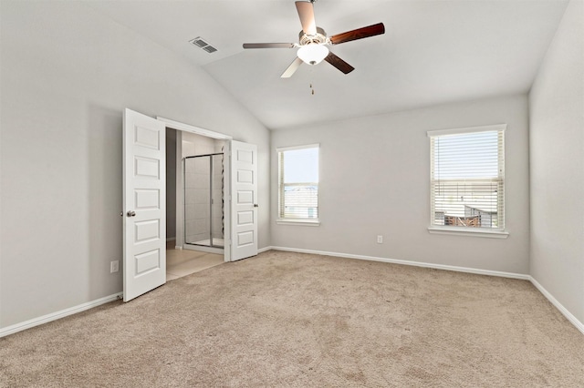 unfurnished bedroom with visible vents, carpet flooring, baseboards, and vaulted ceiling