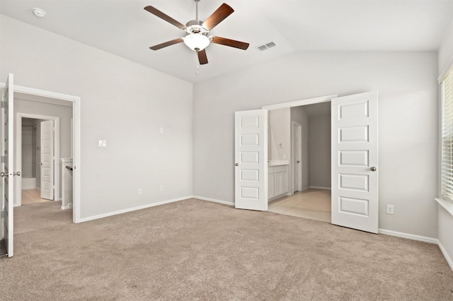 unfurnished bedroom featuring visible vents, light carpet, a ceiling fan, baseboards, and vaulted ceiling