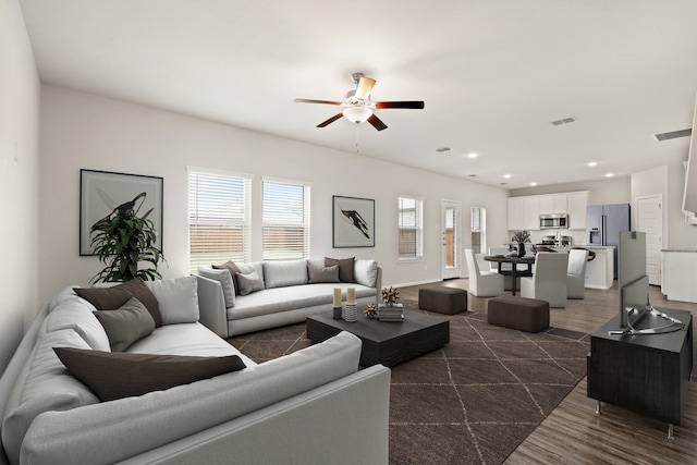 living room featuring recessed lighting, visible vents, dark wood-type flooring, and ceiling fan