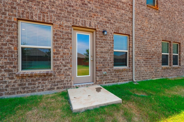 entrance to property with brick siding