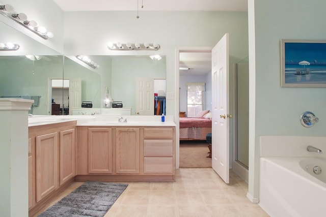 ensuite bathroom with ensuite bath, double vanity, tile patterned flooring, a garden tub, and a shower with door