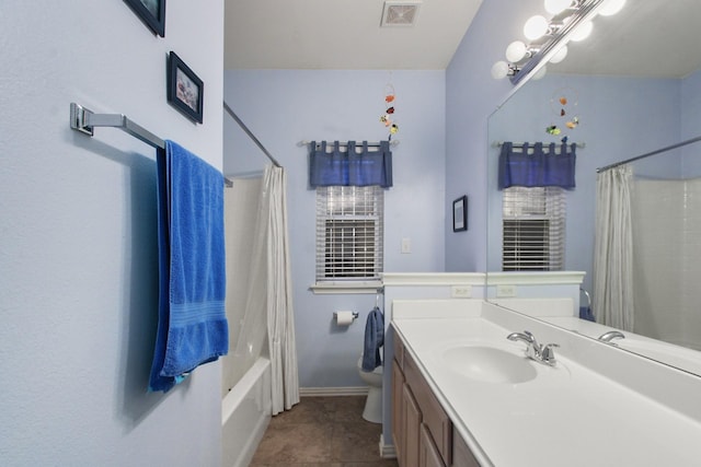 bathroom featuring visible vents, baseboards, toilet, shower / bath combo, and vanity