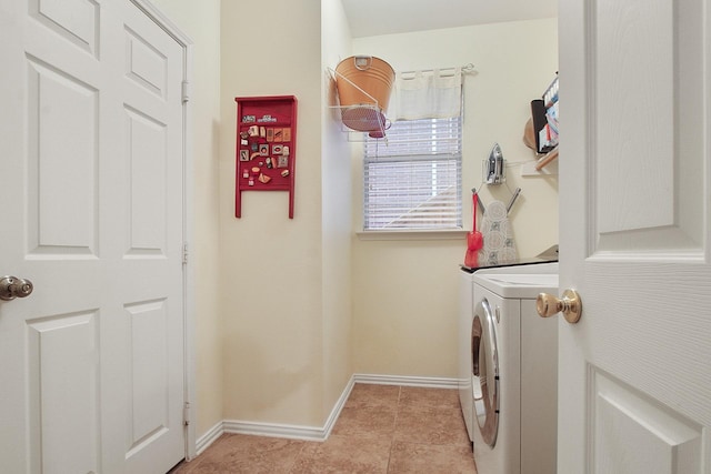 washroom featuring light tile patterned floors, baseboards, independent washer and dryer, and laundry area