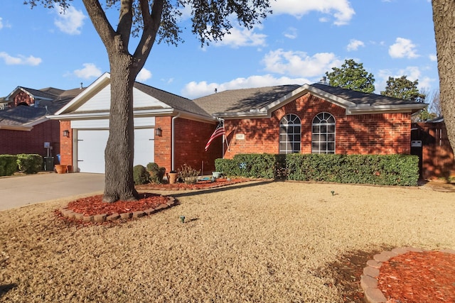 single story home featuring brick siding, driveway, and an attached garage