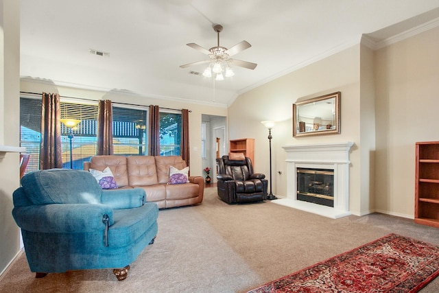 carpeted living room with visible vents, crown molding, baseboards, and a glass covered fireplace