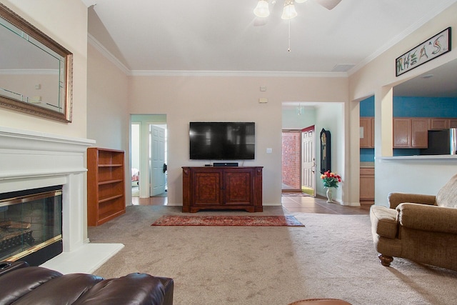 carpeted living room featuring tile patterned floors, a glass covered fireplace, visible vents, and ornamental molding