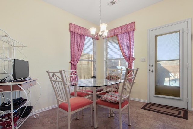 dining room featuring tile patterned flooring, baseboards, visible vents, and a chandelier