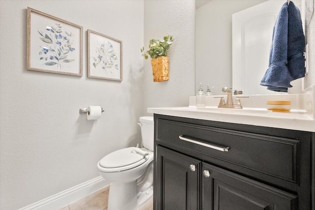 half bath with tile patterned floors, baseboards, toilet, and vanity