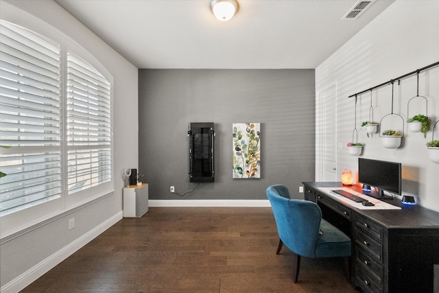 office featuring visible vents, baseboards, and wood finished floors