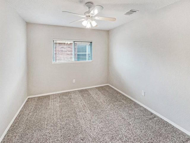 spare room featuring visible vents, carpet flooring, a ceiling fan, and baseboards