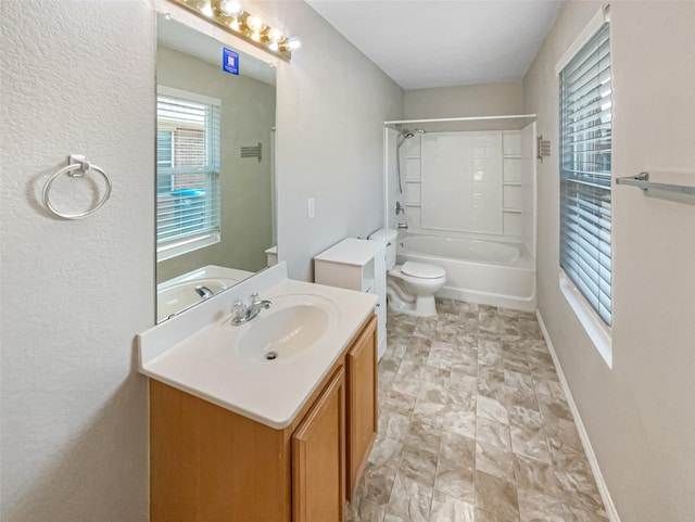 full bath featuring vanity, toilet, baseboards, and shower / bathtub combination