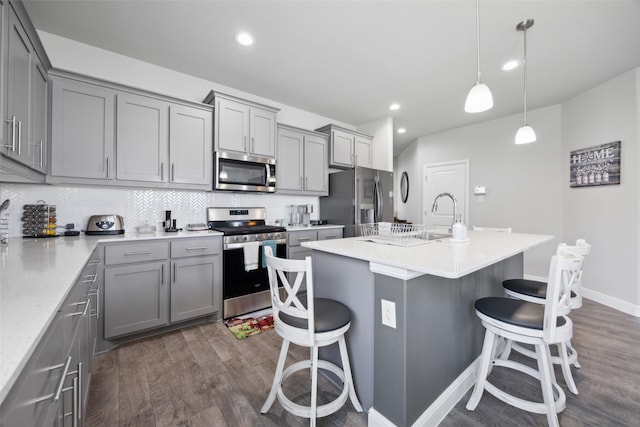 16032 Bronte Ln, Fort Worth, TX 76247 - kitchen featuring a breakfast bar area, appliances with stainless steel finishes, and gray cabinetry