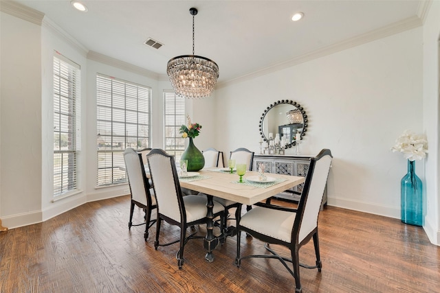 dining area featuring crown molding, wood finished floors, visible vents, and baseboards