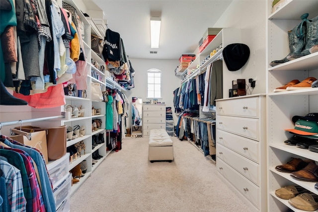 walk in closet with visible vents and carpet floors