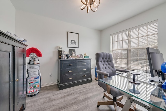 office area featuring baseboards and light wood finished floors