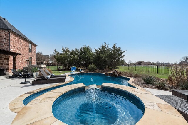 view of pool featuring a patio area, a fenced in pool, an in ground hot tub, and fence