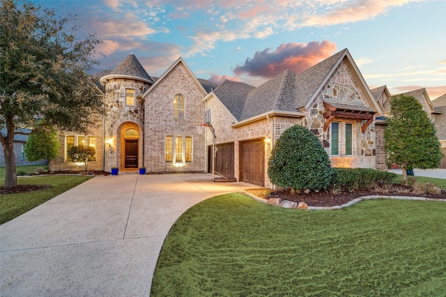 view of front facade featuring a front lawn, brick siding, driveway, and a shingled roof