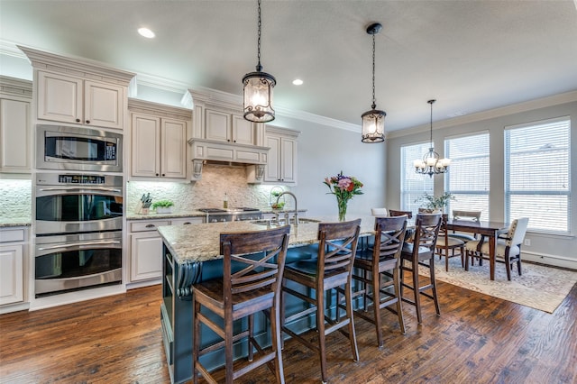 kitchen with dark wood-type flooring, ornamental molding, a sink, appliances with stainless steel finishes, and decorative backsplash