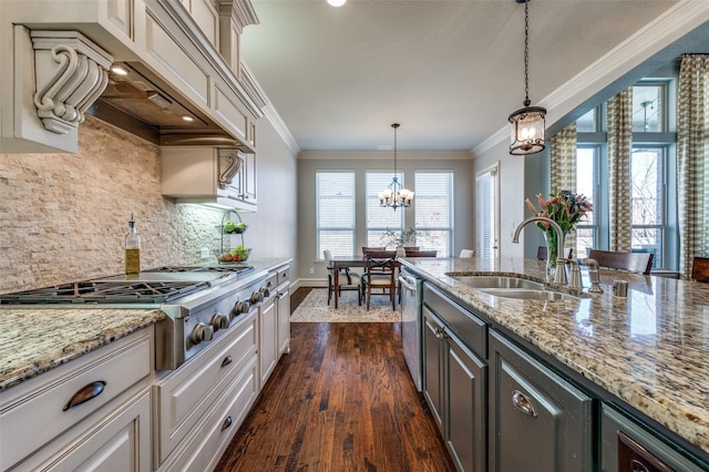 kitchen with ornamental molding, a healthy amount of sunlight, appliances with stainless steel finishes, and a sink