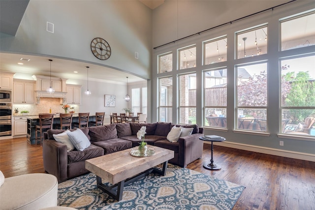 dining space featuring a chandelier, visible vents, ornamental molding, arched walkways, and wood finished floors