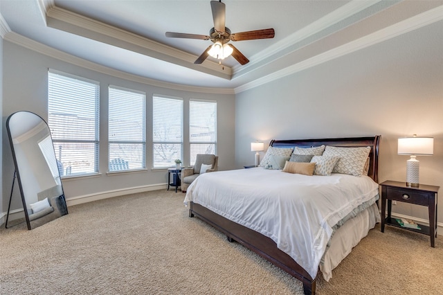 bedroom featuring crown molding, ceiling fan, baseboards, carpet, and a tray ceiling