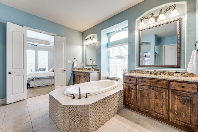 full bathroom with a raised ceiling, tile patterned floors, a bath, and a wealth of natural light