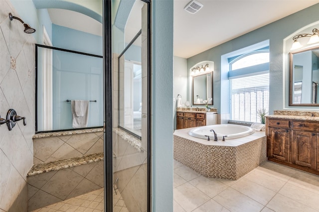 full bath with a stall shower, visible vents, a bath, and tile patterned floors