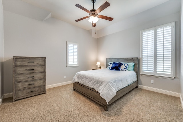 bedroom with a ceiling fan, carpet, and baseboards