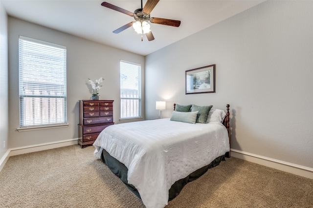 bedroom with ceiling fan, baseboards, and carpet floors