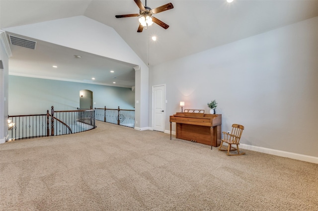 sitting room with carpet flooring, an upstairs landing, a ceiling fan, and visible vents