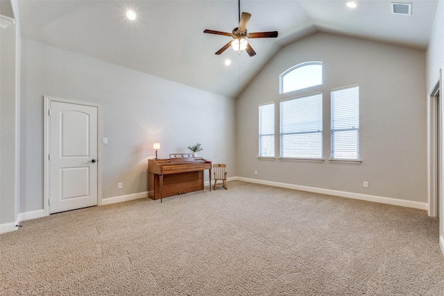 interior space with baseboards, visible vents, high vaulted ceiling, ceiling fan, and carpet flooring