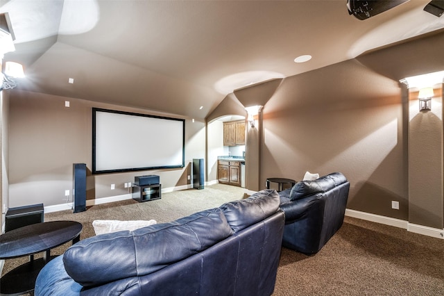 cinema with lofted ceiling, carpet flooring, and baseboards