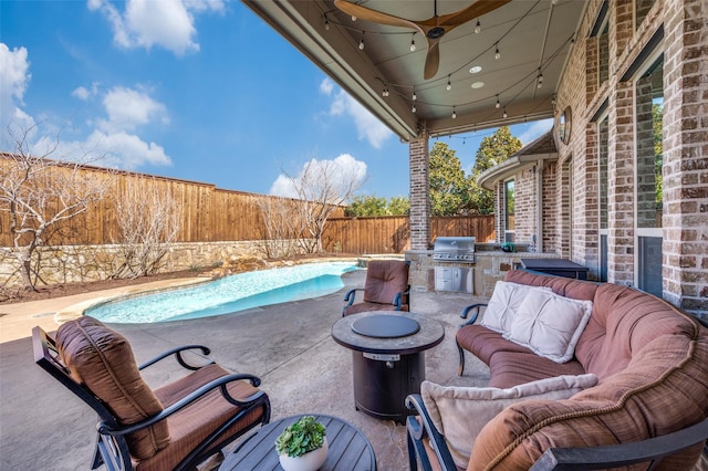 view of patio featuring a fenced backyard, grilling area, exterior kitchen, a fenced in pool, and an outdoor hangout area