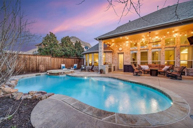 view of pool with an outdoor living space, a fenced in pool, a patio, and fence