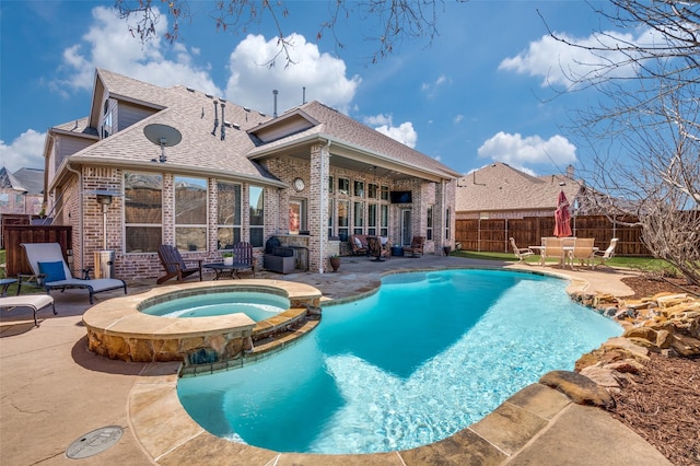 view of swimming pool with a fenced backyard, a pool with connected hot tub, and a patio