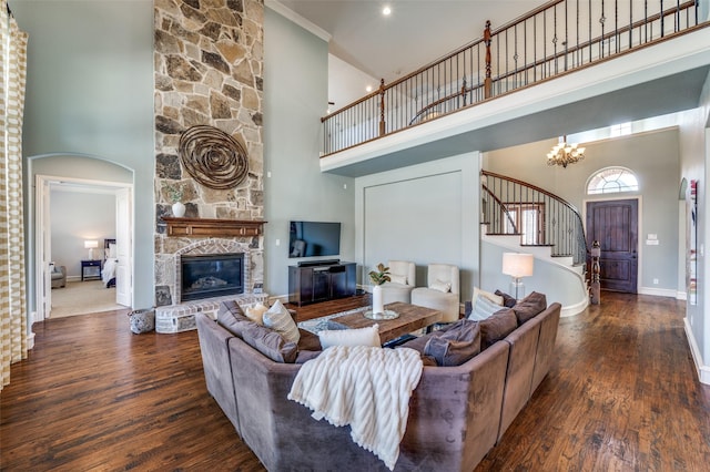 living area featuring stairs, a high ceiling, and wood finished floors