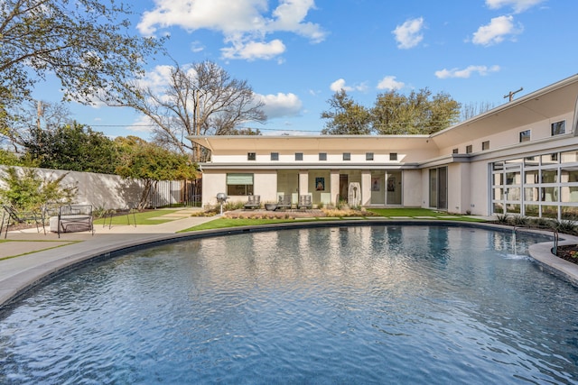 view of swimming pool with a patio and fence