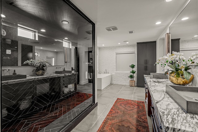 bathroom featuring a tub, visible vents, vanity, and recessed lighting