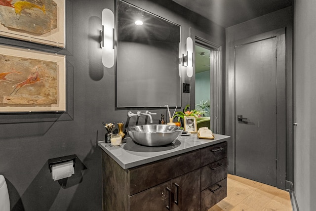 bathroom with vanity and wood finished floors