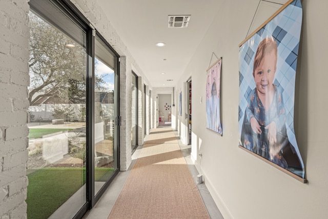 hallway featuring visible vents, recessed lighting, and baseboards