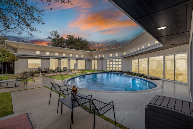 outdoor pool with a patio area