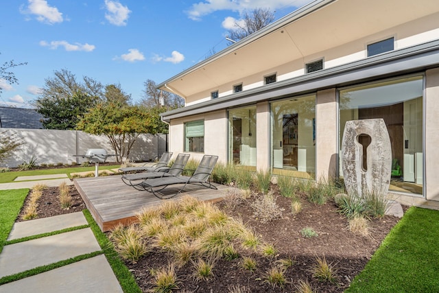 exterior space featuring a wooden deck and fence