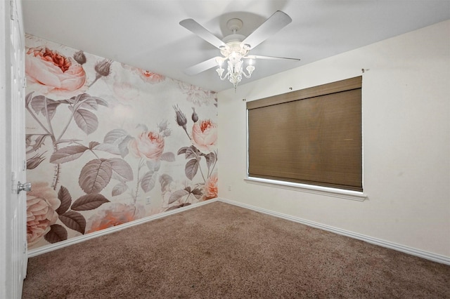 empty room with carpet flooring, ceiling fan, wallpapered walls, and baseboards