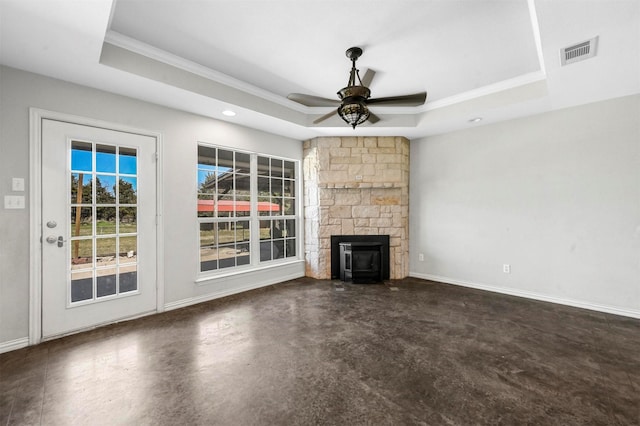 unfurnished living room with visible vents, concrete floors, a raised ceiling, and a ceiling fan