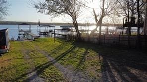 view of yard featuring a water view and fence