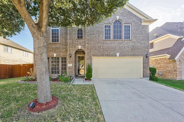 traditional-style house featuring brick siding, concrete driveway, a front yard, and fence