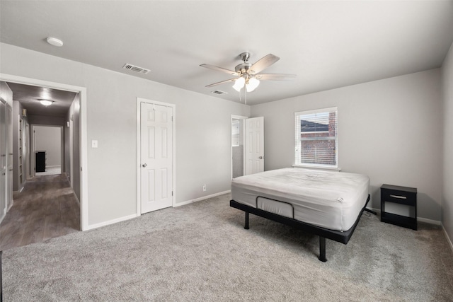 bedroom with visible vents, carpet flooring, and baseboards