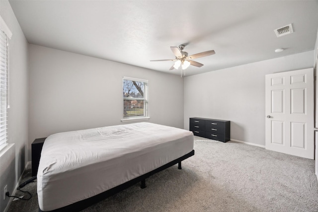 bedroom with visible vents, carpet floors, baseboards, and ceiling fan