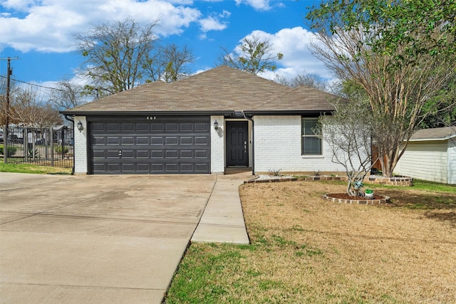 ranch-style home featuring brick siding, an attached garage, driveway, and fence