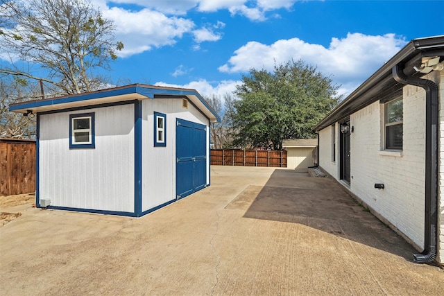 view of shed with fence